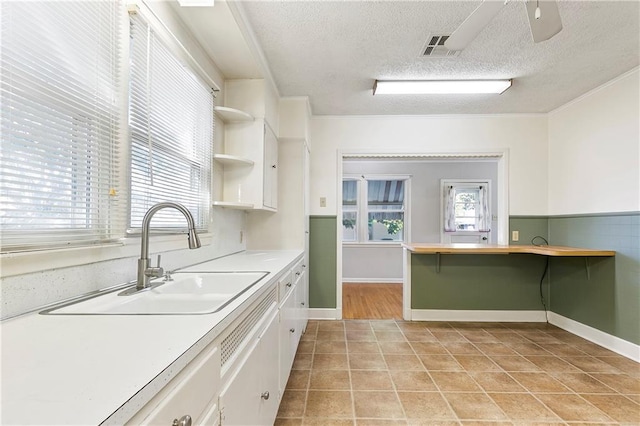 501 Gaudet Dr, Marrero, LA 70072 - kitchen with a sink, white cabinets, a textured ceiling, open shelves, and light countertops