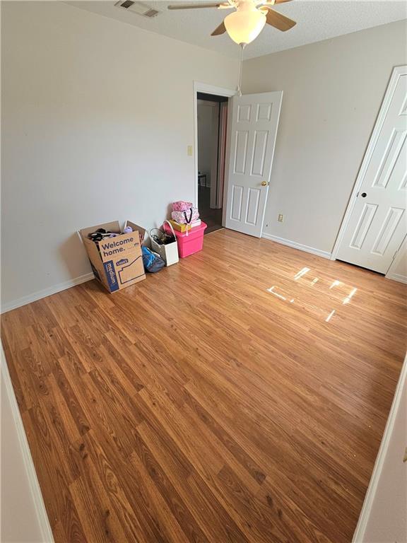 2724 Marisha Ct, Marrero, LA 70072 - unfurnished bedroom featuring light wood-style floors, ceiling fan, and baseboards