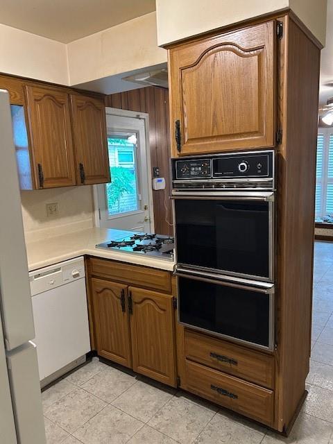 523 Beverly Garden Dr, Metairie, LA 70001 - kitchen with white appliances, light countertops, a warming drawer, and light tile patterned flooring