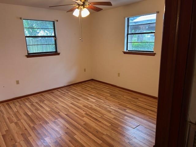 523 Beverly Garden Dr, Metairie, LA 70001 - spare room with plenty of natural light, light wood-style flooring, a ceiling fan, and baseboards