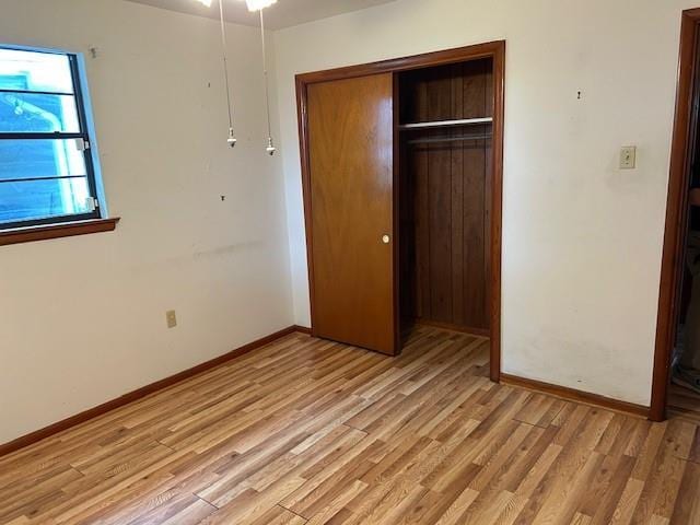 523 Beverly Garden Dr, Metairie, LA 70001 - unfurnished bedroom featuring a closet, light wood-style flooring, and baseboards