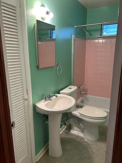 523 Beverly Garden Dr, Metairie, LA 70001 - bathroom featuring a closet, toilet, washtub / shower combination, tile patterned floors, and a sink