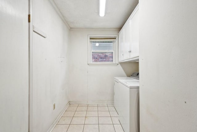 1400 Velma St, Metairie, LA 70001 - laundry room with cabinet space, washing machine and clothes dryer, light tile patterned flooring, and baseboards