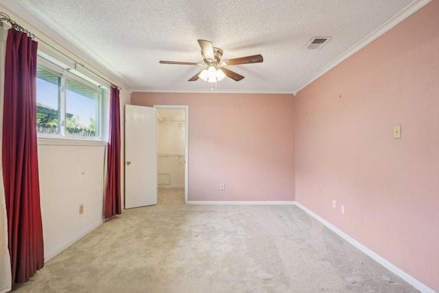 1400 Velma St, Metairie, LA 70001 - unfurnished bedroom featuring carpet flooring, a textured ceiling, crown molding, baseboards, and a spacious closet