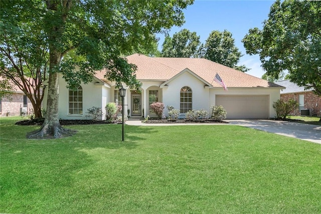 2308 Crossing Ct, Mandeville, LA 70448 - view of front of property featuring driveway, an attached garage, stucco siding, a front yard, and central air condition unit