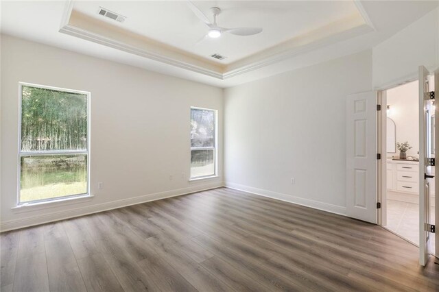 2308 Crossing Ct, Mandeville, LA 70448 - spare room featuring a raised ceiling, a ceiling fan, wood finished floors, and baseboards