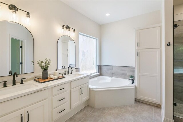 2308 Crossing Ct, Mandeville, LA 70448 - bathroom featuring double vanity, a bath, a shower stall, tile patterned floors, and recessed lighting