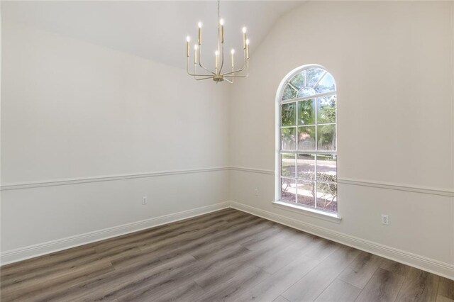 2308 Crossing Ct, Mandeville, LA 70448 - unfurnished room featuring a chandelier, wood finished floors, baseboards, and vaulted ceiling