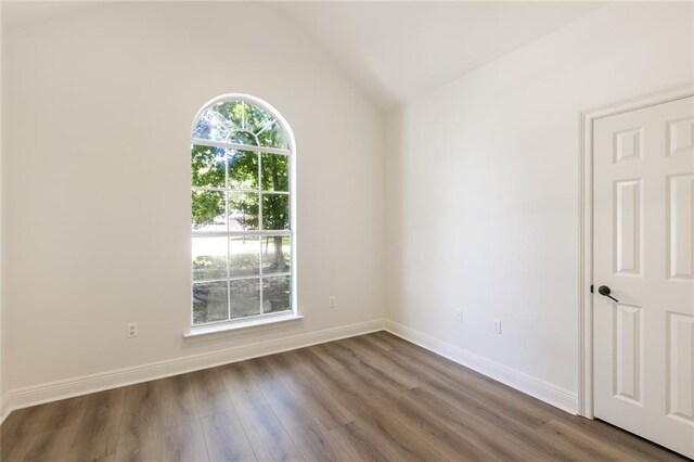 2308 Crossing Ct, Mandeville, LA 70448 - spare room featuring vaulted ceiling, wood finished floors, and baseboards