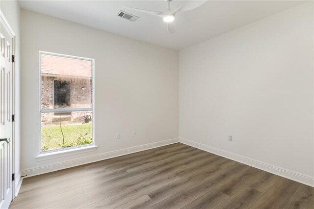 2308 Crossing Ct, Mandeville, LA 70448 - empty room featuring wood finished floors, a ceiling fan, and baseboards
