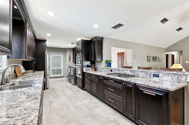 4321 San Remo Rd, New Orleans, LA 70129 - kitchen featuring a sink, appliances with stainless steel finishes, a peninsula, light stone countertops, and light marble finish floors