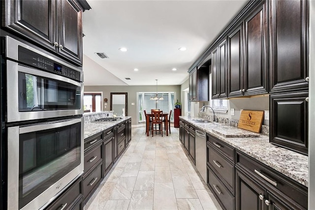 4321 San Remo Rd, New Orleans, LA 70129 - kitchen featuring stainless steel appliances, a sink, plenty of natural light, light stone counters, and recessed lighting