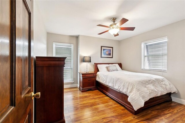 4321 San Remo Rd, New Orleans, LA 70129 - bedroom featuring baseboards, light wood finished floors, and a ceiling fan