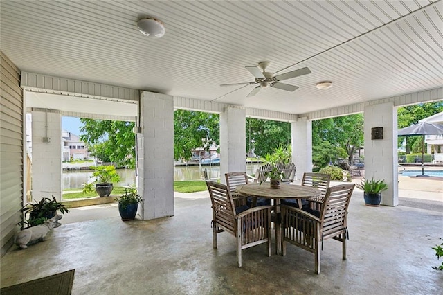 4321 San Remo Rd, New Orleans, LA 70129 - view of patio / terrace with outdoor dining space, ceiling fan, a water view, and an outdoor pool