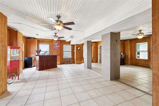 4321 San Remo Rd, New Orleans, LA 70129 - unfurnished living room with wooden walls, a ceiling fan, and light tile patterned floors