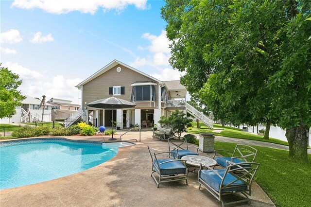 4321 San Remo Rd, New Orleans, LA 70129 - view of pool with stairs, a patio area, and a lawn