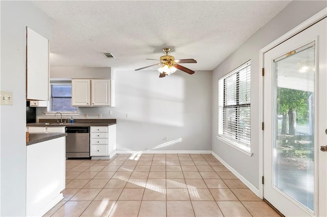 206 Chubasco Ln, Slidell, LA 70458 - kitchen with stainless steel dishwasher, dark countertops, ceiling fan, light tile patterned flooring, and a sink
