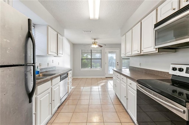 206 Chubasco Ln, Slidell, LA 70458 - kitchen with appliances with stainless steel finishes, white cabinets, and a textured ceiling