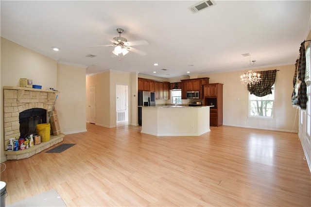 105 Norton Ave, Arabi, LA 70032 - unfurnished living room featuring a chandelier, a stone fireplace, a sink, ceiling fan, and healthy amount of natural light