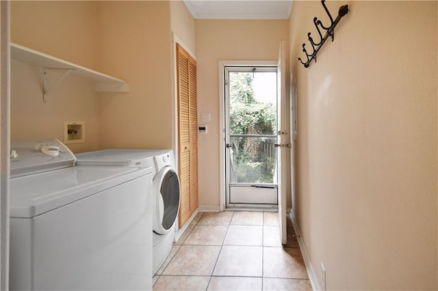 105 Norton Ave, Arabi, LA 70032 - laundry area with washing machine and clothes dryer, baseboards, light tile patterned floors, and crown molding