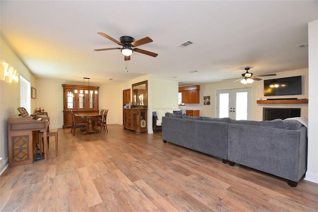 206 Loop Dr, Slidell, LA 70458 - living area with a ceiling fan, light wood finished floors, french doors, and baseboards