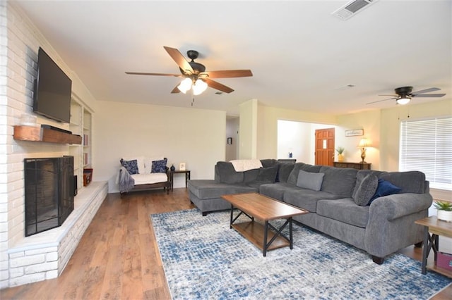 206 Loop Dr, Slidell, LA 70458 - living area featuring ceiling fan, wood finished floors, and a brick fireplace