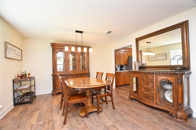 206 Loop Dr, Slidell, LA 70458 - dining space featuring wood finished floors, baseboards, and a chandelier