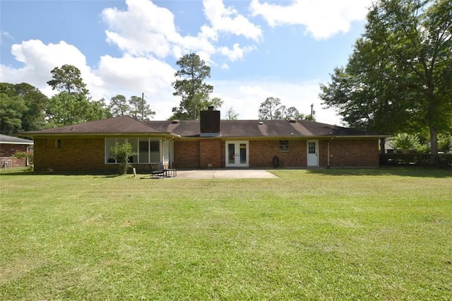 206 Loop Dr, Slidell, LA 70458 - rear view of property with french doors, a chimney, and a lawn