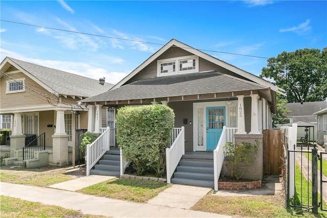 182527 Cambronne St, New Orleans, LA 70118 - view of front of home featuring covered porch, brick siding, and roof with shingles