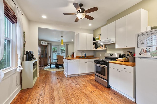 182527 Cambronne St, New Orleans, LA 70118 - kitchen with white appliances, open shelves, butcher block countertops, under cabinet range hood, and light wood-style flooring