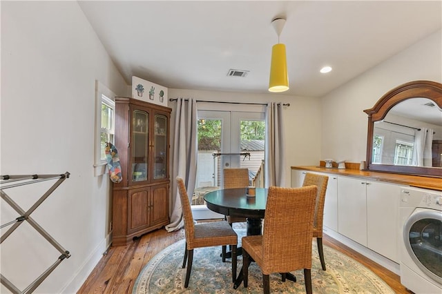 182527 Cambronne St, New Orleans, LA 70118 - dining room featuring washer / dryer, light wood-style floors, french doors, baseboards, and recessed lighting
