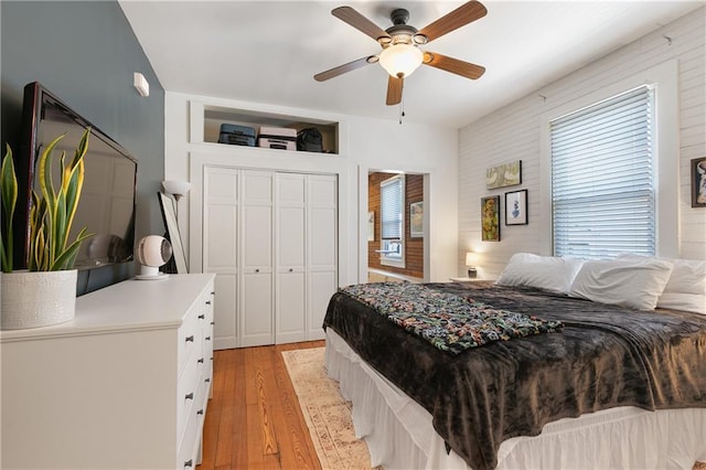 182527 Cambronne St, New Orleans, LA 70118 - bedroom with light wood-style floors, multiple windows, a ceiling fan, and a closet