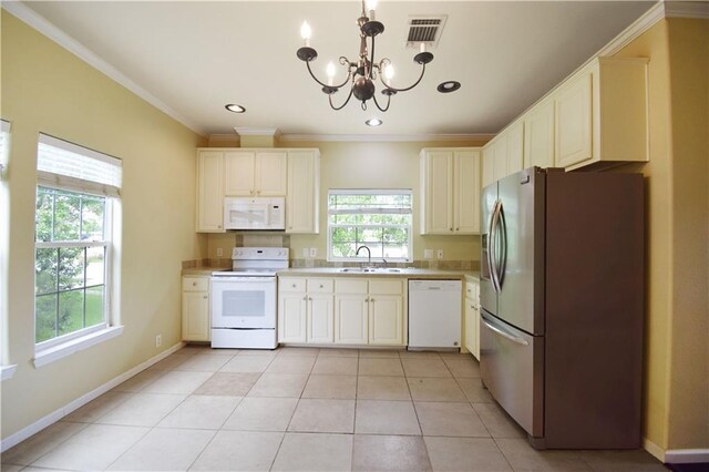 109 Norton Ave, Arabi, LA 70032 - kitchen with white appliances, a chandelier, a sink, light countertops, and light tile patterned floors