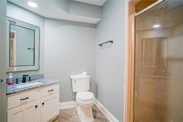 115 Devereux Dr, Slidell, LA 70461 - bathroom featuring vanity, toilet, wood finished floors, a stall shower, and baseboards