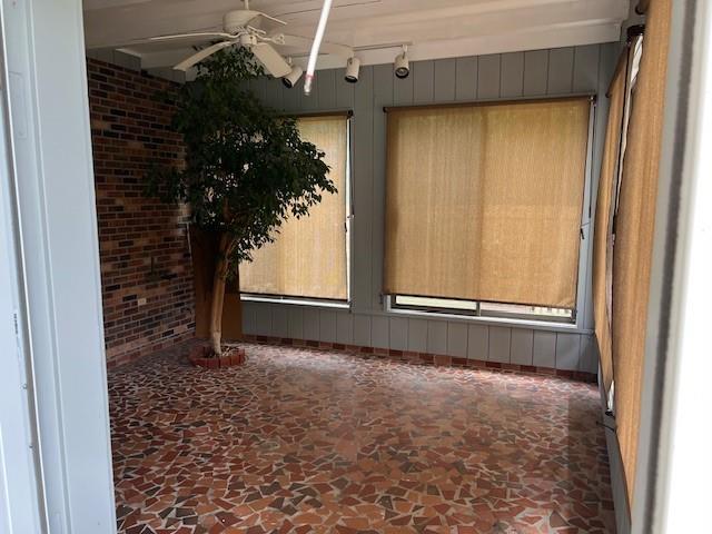 115 Devereux Dr, Slidell, LA 70461 - empty room featuring ceiling fan, stone floors, and rail lighting