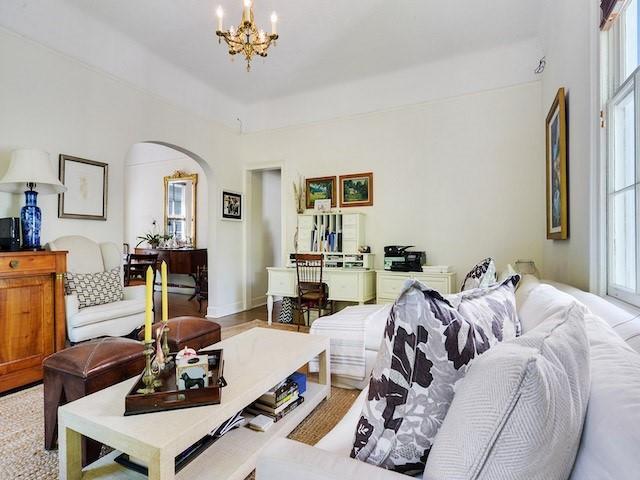 39294 Broadway St, New Orleans, LA 70118 - living room featuring arched walkways, a chandelier, and plenty of natural light