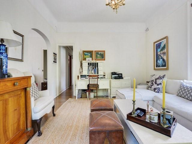 39294 Broadway St, New Orleans, LA 70118 - living area with arched walkways and light wood finished floors