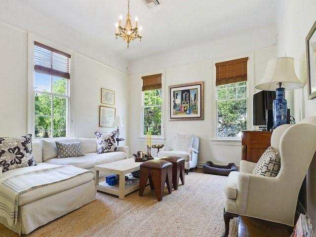 39294 Broadway St, New Orleans, LA 70118 - living room featuring plenty of natural light, a chandelier, and wood finished floors