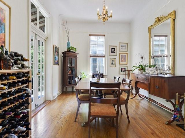 39294 Broadway St, New Orleans, LA 70118 - dining space featuring wood finished floors and a chandelier