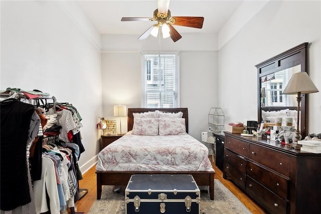 39294 Broadway St, New Orleans, LA 70118 - bedroom with multiple windows, light wood-style flooring, baseboards, and ceiling fan