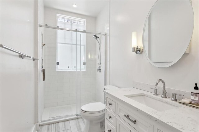 39294 Broadway St, New Orleans, LA 70118 - bathroom featuring vanity, a shower stall, and toilet