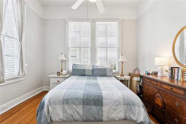 39294 Broadway St, New Orleans, LA 70118 - bedroom featuring multiple windows, wood finished floors, baseboards, and ceiling fan