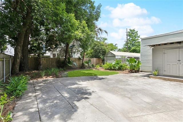 39294 Broadway St, New Orleans, LA 70118 - fenced backyard featuring a patio and an outdoor structure