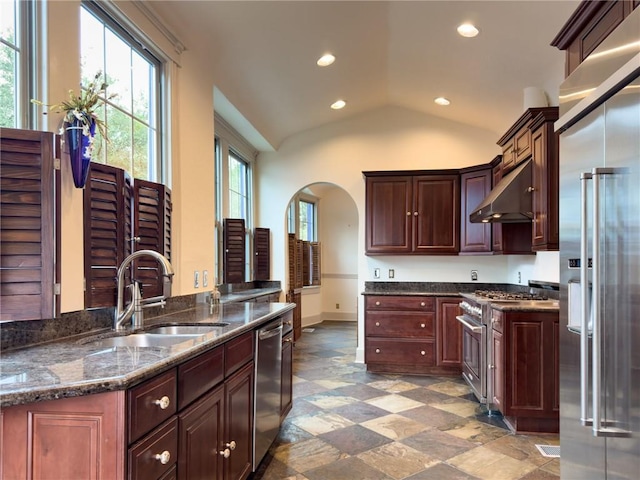 2508 Joseph St, New Orleans, LA 70115 - kitchen featuring high end appliances, under cabinet range hood, a sink, vaulted ceiling, and recessed lighting