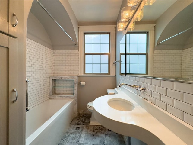 2508 Joseph St, New Orleans, LA 70115 - bathroom with toilet, baseboards, and a chandelier