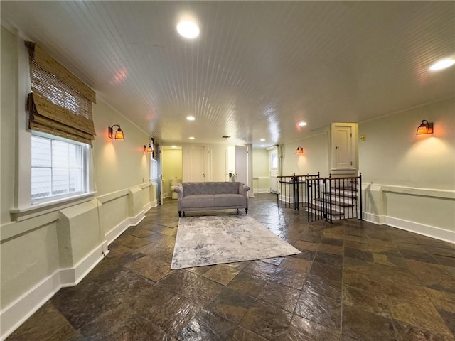 2508 Joseph St, New Orleans, LA 70115 - living room with stone tile flooring, recessed lighting, a wainscoted wall, and baseboards