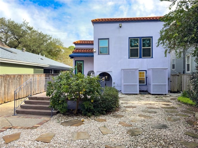 2508 Joseph St, New Orleans, LA 70115 - back of house with a tiled roof and stucco siding