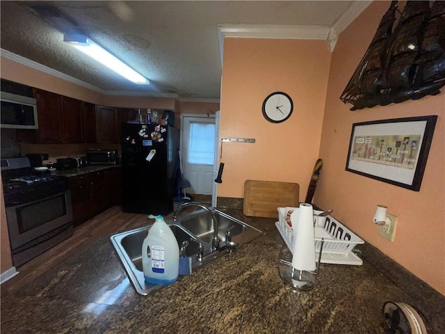 3034 Clouet St, New Orleans, LA 70126 - kitchen with stainless steel appliances, ornamental molding, dark countertops, dark brown cabinets, and a sink