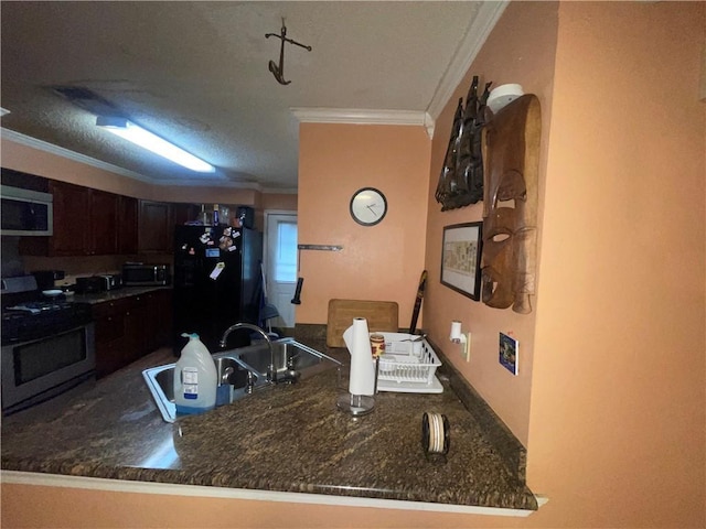 3034 Clouet St, New Orleans, LA 70126 - kitchen with appliances with stainless steel finishes, ornamental molding, a sink, dark brown cabinets, and a peninsula