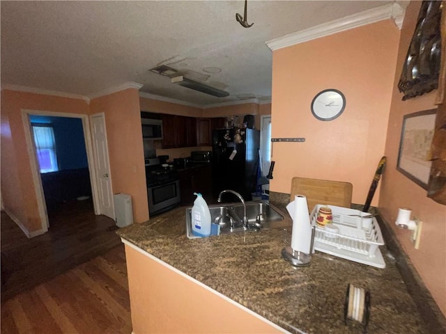 3034 Clouet St, New Orleans, LA 70126 - kitchen featuring stainless steel appliances, ornamental molding, dark wood-style flooring, dark countertops, and a textured ceiling